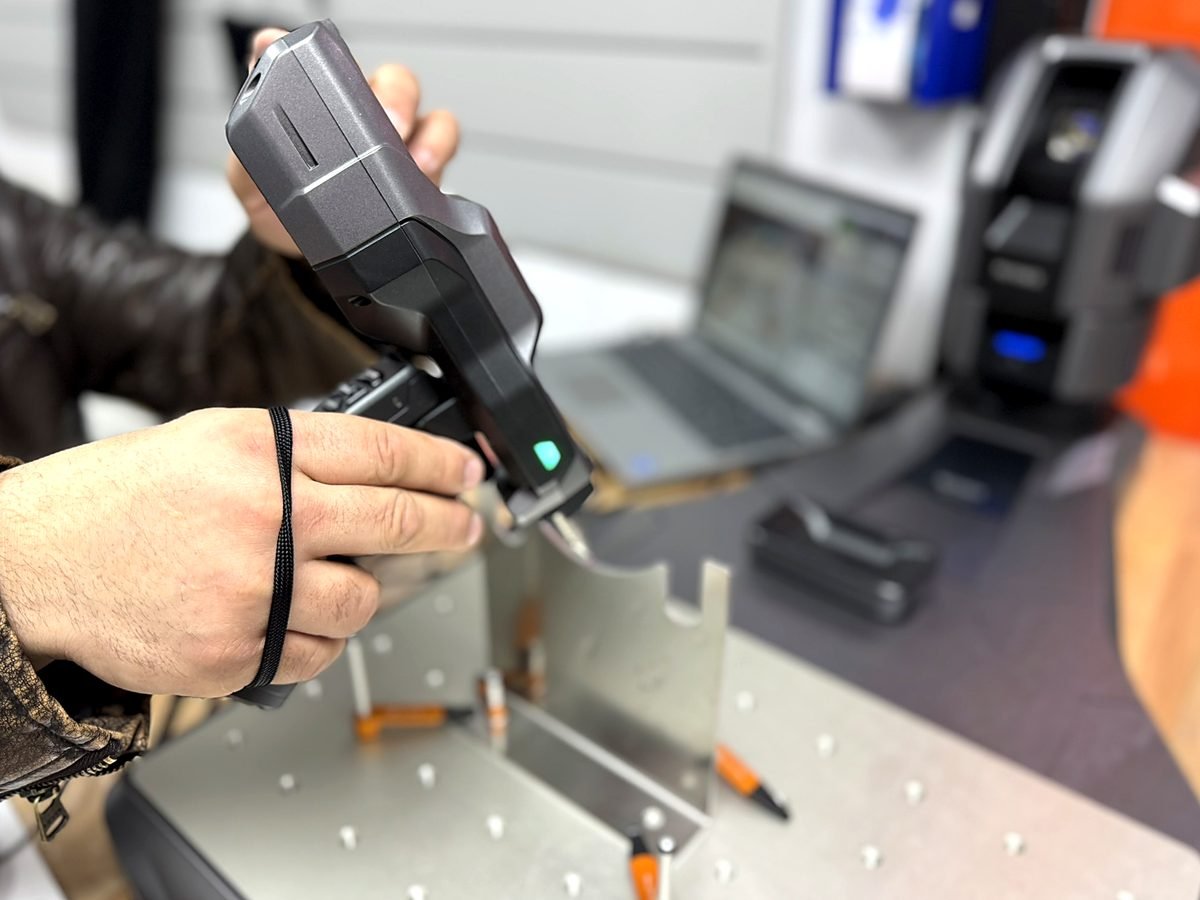 Handheld 3D scanner inspecting a formed sheet metal part at ACP Waterjet