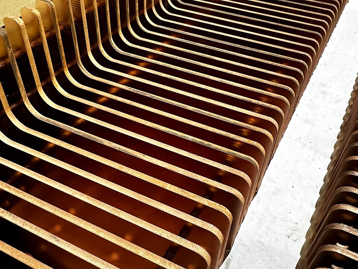 Stack of waterjet cut copper busbars at ACP Waterjet
