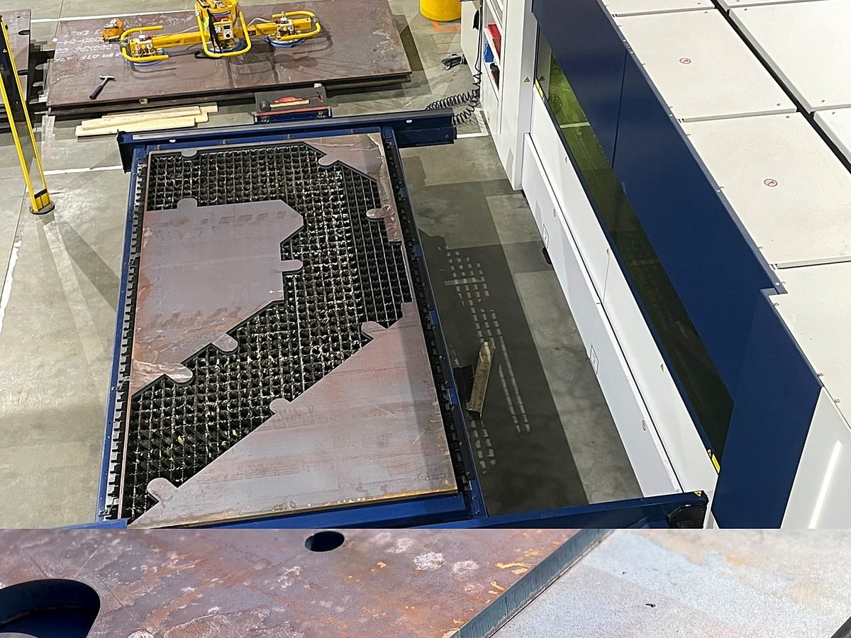 Fiber laser cutting machine with a large cut steel sheet on the bed at ACP Waterjet in Littleton, MA