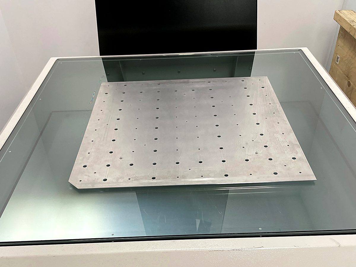A laser cut perforated plate on the inspection stage at ACP Waterjet