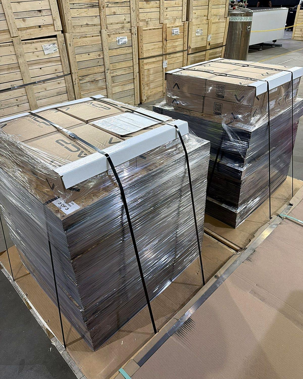 Strapped and wrapped pallet of finished metal parts ready to ship from ACP Waterjet