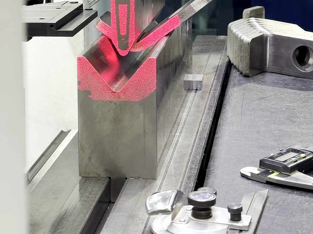 A part bending on the TRUMPF press brake, the red safety beams across the die, at ACP Waterjet