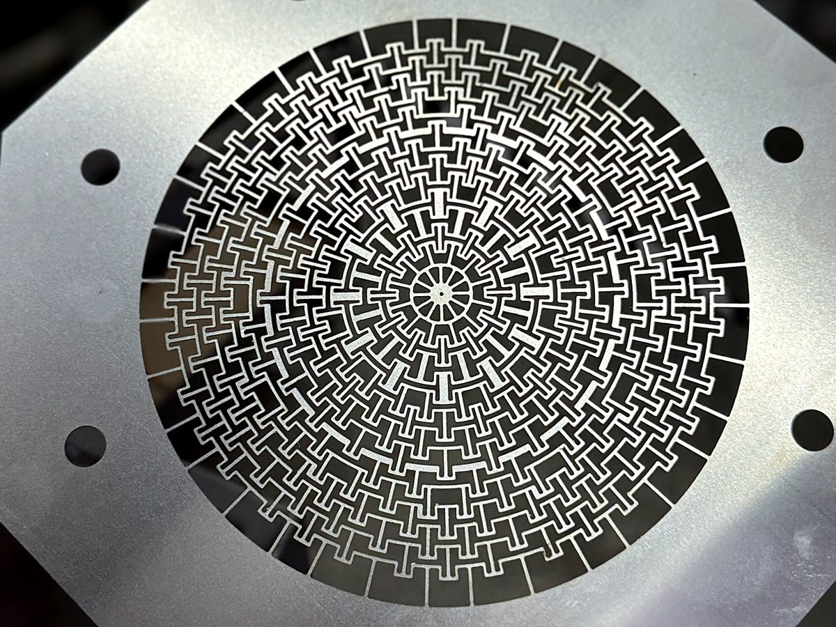 Laser cut stainless steel shim with an intricate mesh profile at ACP Waterjet