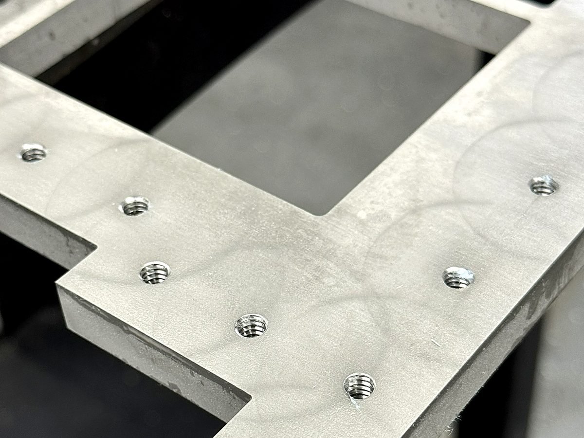 Waterjet cut aluminum frame with in house tapped holes at ACP Waterjet in Littleton, MA