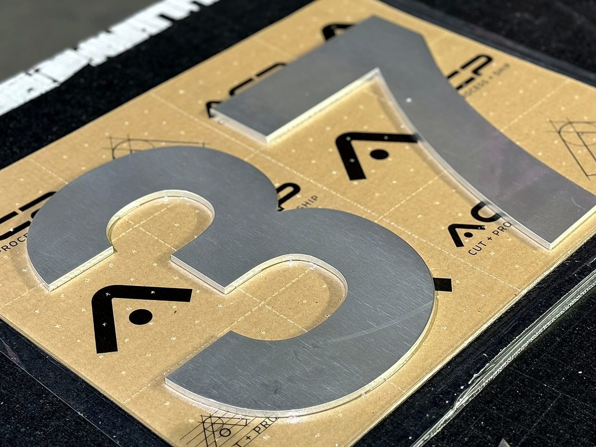 Cut metal parts vacuum packaged for protection before shipping at ACP Waterjet